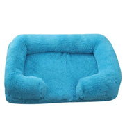 Soft dog sofa bed in blue plush fabric with orthopedic support for medium-sized dogs.