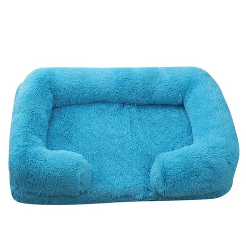 Soft dog sofa bed in blue plush fabric with orthopedic support for medium-sized dogs.