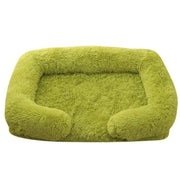 Soft green orthopedic dog sofa bed with plush cushioning and raised edges for medium-sized pets