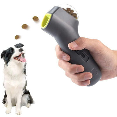 Handheld dog treat launcher device propelling treats for pet training and play with a happy dog ready to catch them