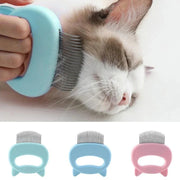 Cat Grooming & Massage Comb with non-slip handle grooming a relaxed cat and available in blue and pink colors