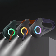 Automatic retractable dog leash with LED flashlight and colorful RGB flow light ring, available in purple, orange, and green.