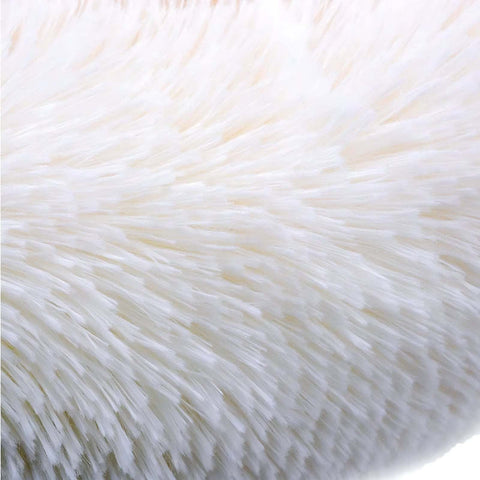 Close-up of soft white plush fabric on a dog sofa bed providing orthopedic comfort and support